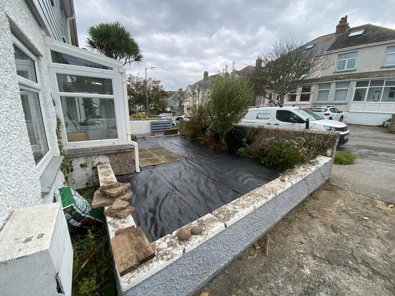 Gravel garden mid transformation, weed matting laid